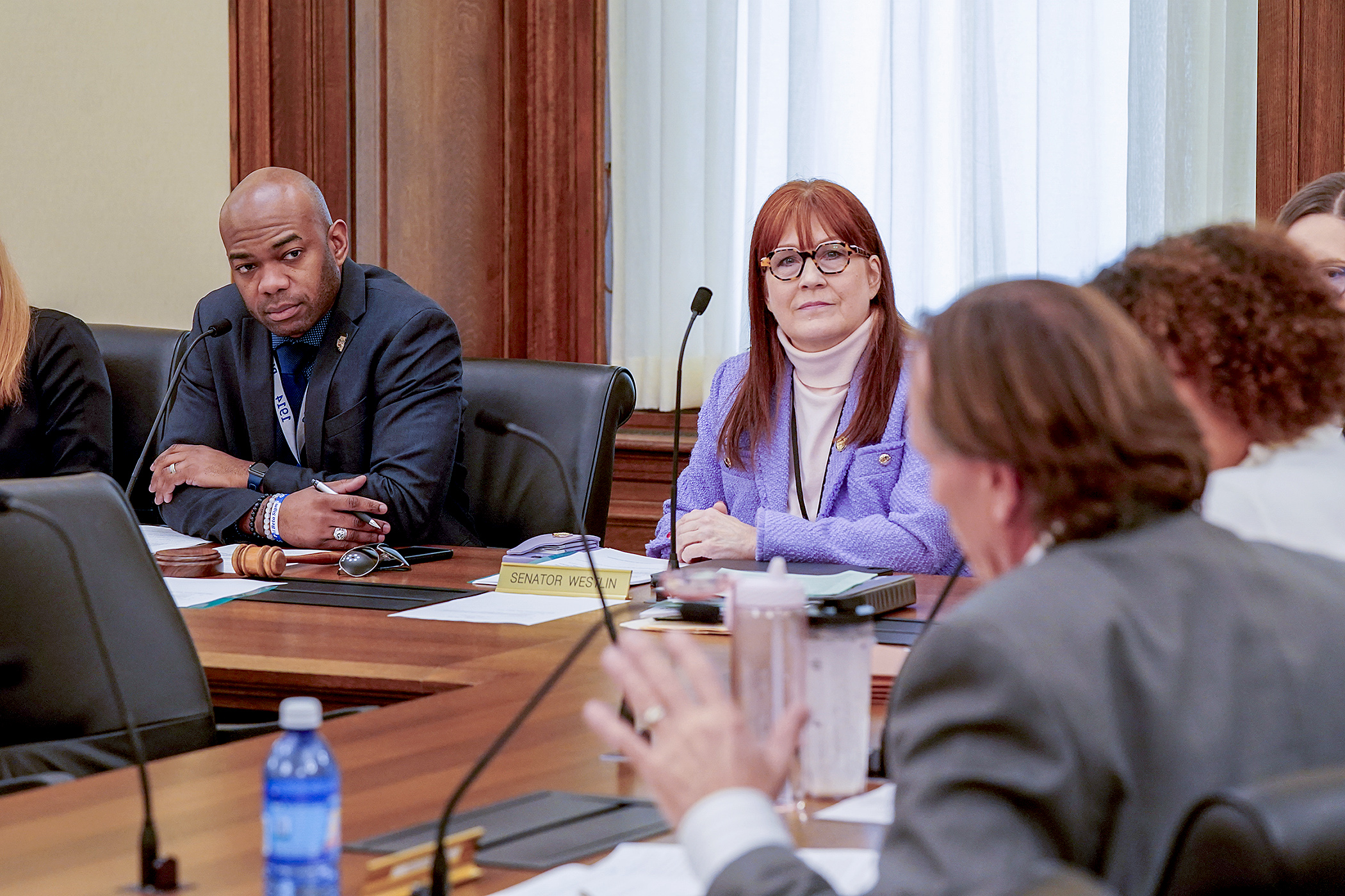 Rep. Cedrick Frazier and Sen. Bonnie Westlin listen to Sen. Jim Abeler during Tuesday’s conference committee regarding the school resource officer bill. (Photo by Michele Jokinen) 